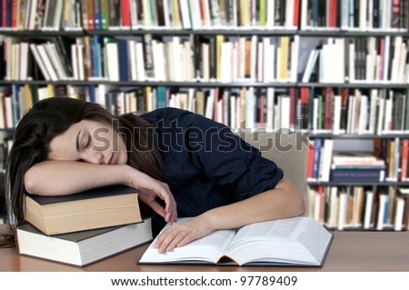 Tired teenager, sleeping on the books