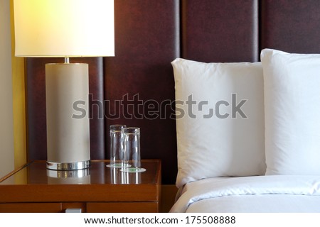 bedside table and lamp in hotel room