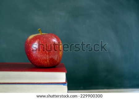 red apple and books in classroom