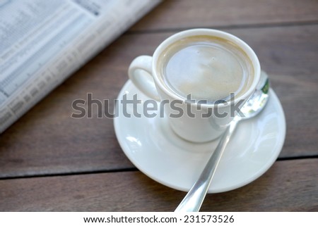espresso and newspaper on table