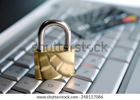 computer and big lock with credit card