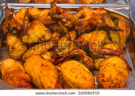 Tasty grilled roasted chicken in butcher shop