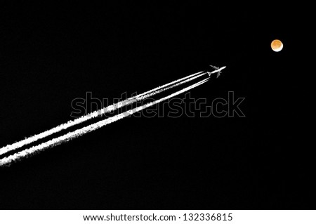 Airplane flies in direction moon at night