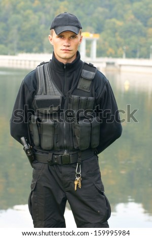 Security guard in uniform and armed