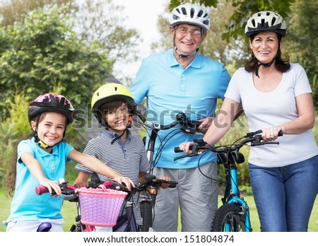 Grandparents And Grandchildren On Cycle Ride In Countryside