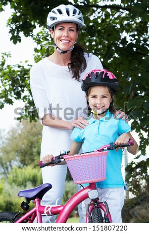 Mother And Daughter On Cycle Ride In Countryside