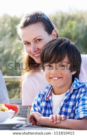 Portrait Of Mother And Son Hugging Outdoors