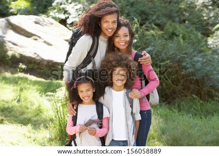 Family Group Hiking In Woods Together