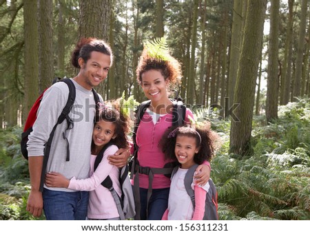 Family Group Hiking In Woods Together