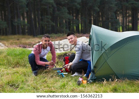 Two Young Men On Camping Trip In Countryside