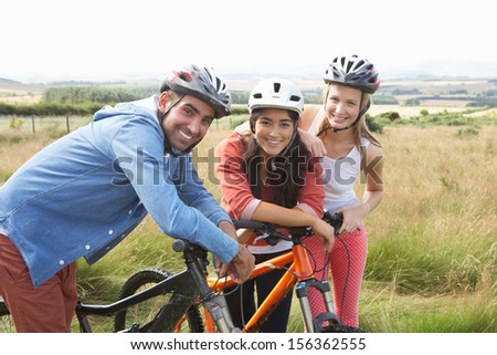 Group Of Young People Cycling In Countryside