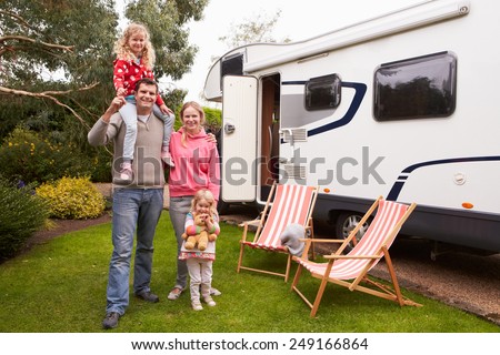 Family Enjoying Camping Holiday In Camper Van