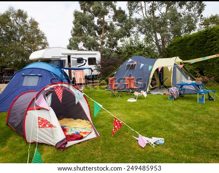 Campsite With Pitched Tents And Campervan