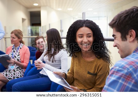 College Students Having Informal Meeting With Tutors