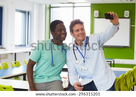 Student And Tutor Studying Medicine Taking Selfie