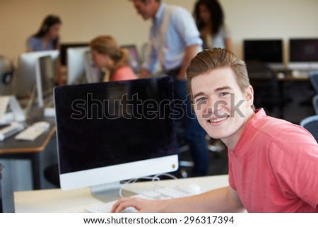 Male College Student Using Computer In Classroom