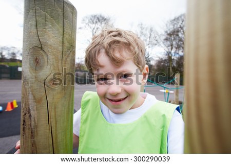 Boy On Climbing Frame In School Physical Education Class