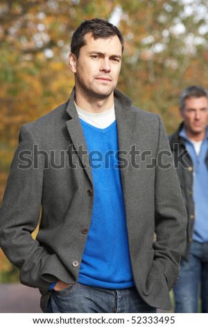 Two Men Standing Outside In Autumn Woodland