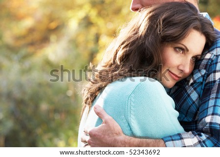 Close Up Of Romantic Couple Embracing By Autumn Woodland