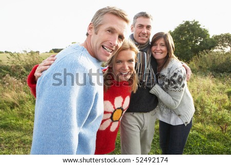 Group Of Friends On Walk In Autumn Countryside Together