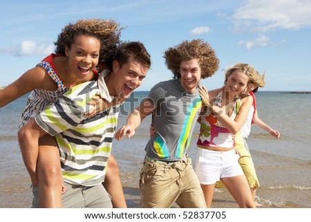 stock photo : Group Of Young Friends Walking Along Summer Shoreline