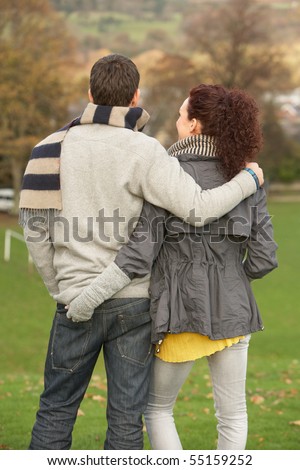 Back View Of Romantic Teenage Couple In Autumn Landscape
