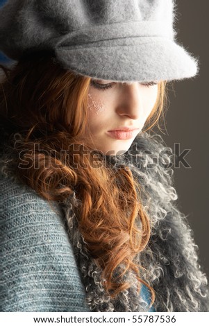 Fashionable Teenage Girl Wearing Cap And Knitwear In Studio