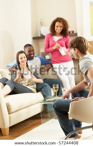 Group Of  Friends Enjoying Chinese Takeaway Meal At Home
