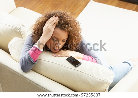 stock-photo-woman-sitting-on-sofa-waiting-for-mobile-phone-at-home-57255637.jpg