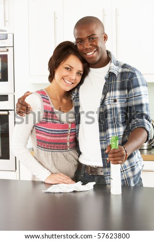 Young Couple Cleaning Cleaning Modern Kitchen - stock photo
