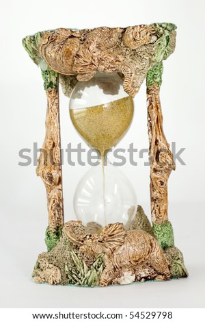 Sand Clock ornament with little elephants  isolated on white background with reflection on hourglass.