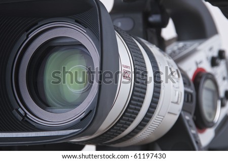 Super close up of Professional Video Camera. The Focus is on the lens and the front part