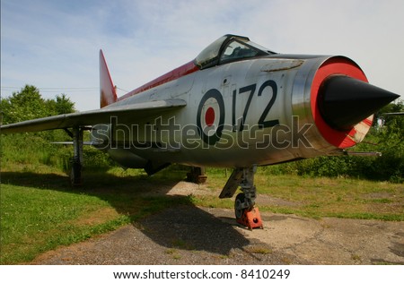 An ex RAF BAC (English Electric) Lightning F-1A XM172 - a supersonic single seater fighter jet fitted with twin Rolls Royce Avon 210R engines. Now retired to an air park looking slightly dilapidated.