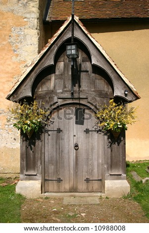Flower decked ancient timber church entrance porch