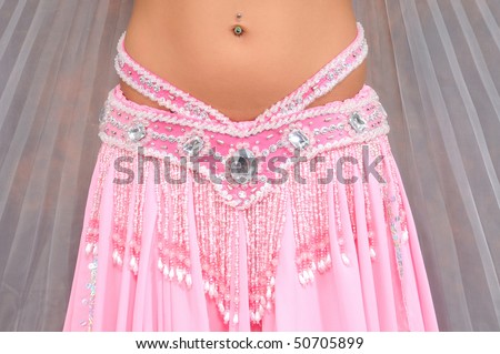 The woman dancing belly dance in traditional costume, body part