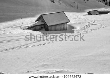 lodges on the snow on the Italian Dolomites, Val di Fassa with blue sky background