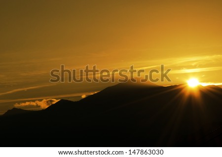 solar panel with mountains and setting sun, green economy