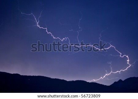 lightning in the night sky background of the Dolomites mountains