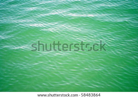 small tidal wave slamming on a sandy beach