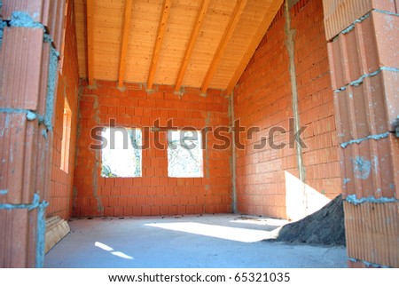 house under construction with red brick