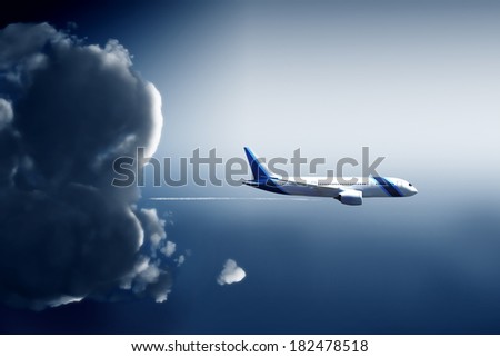 Airliner shape escapes from a storm cloud in widescreen view
