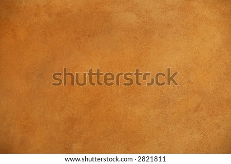 background of a warm brown wall with rough plaster texture