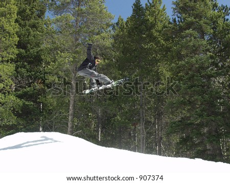 A Snowboarder Jumping in the Park