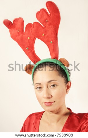 Young woman with antlers hat and red outfit