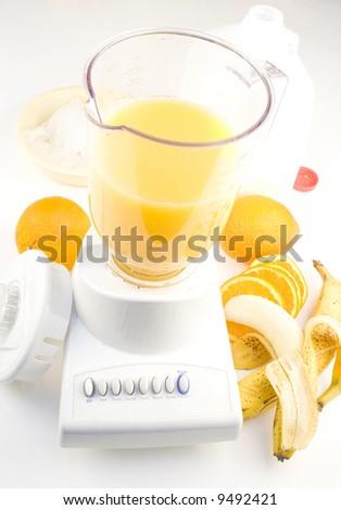 Blender with fruit, ice and milk to make smoothies