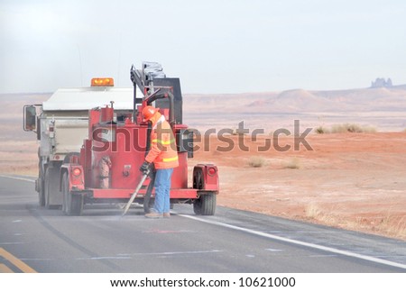 Man with road crew working on rural highway