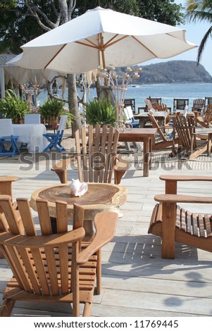 Restaurant table under umbrella overlooking beautiful ocean