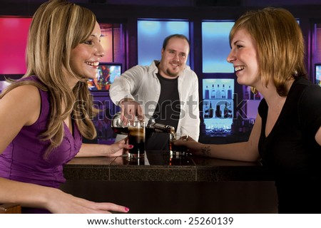 two young women at the bar having drinks