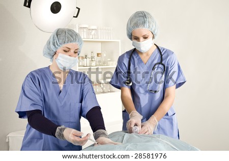 surgical team preparing patient on table with anesthesia and oxygen