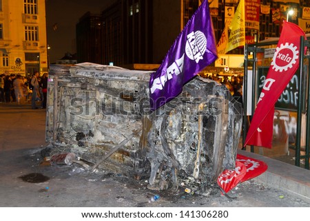 ISTANBUL - JUNE 05: A car overturned and burned in protests on June 05, 2013 in Istanbul, Turkey. Turkish police used disproportionate force to protesters at Taksim in first three days.